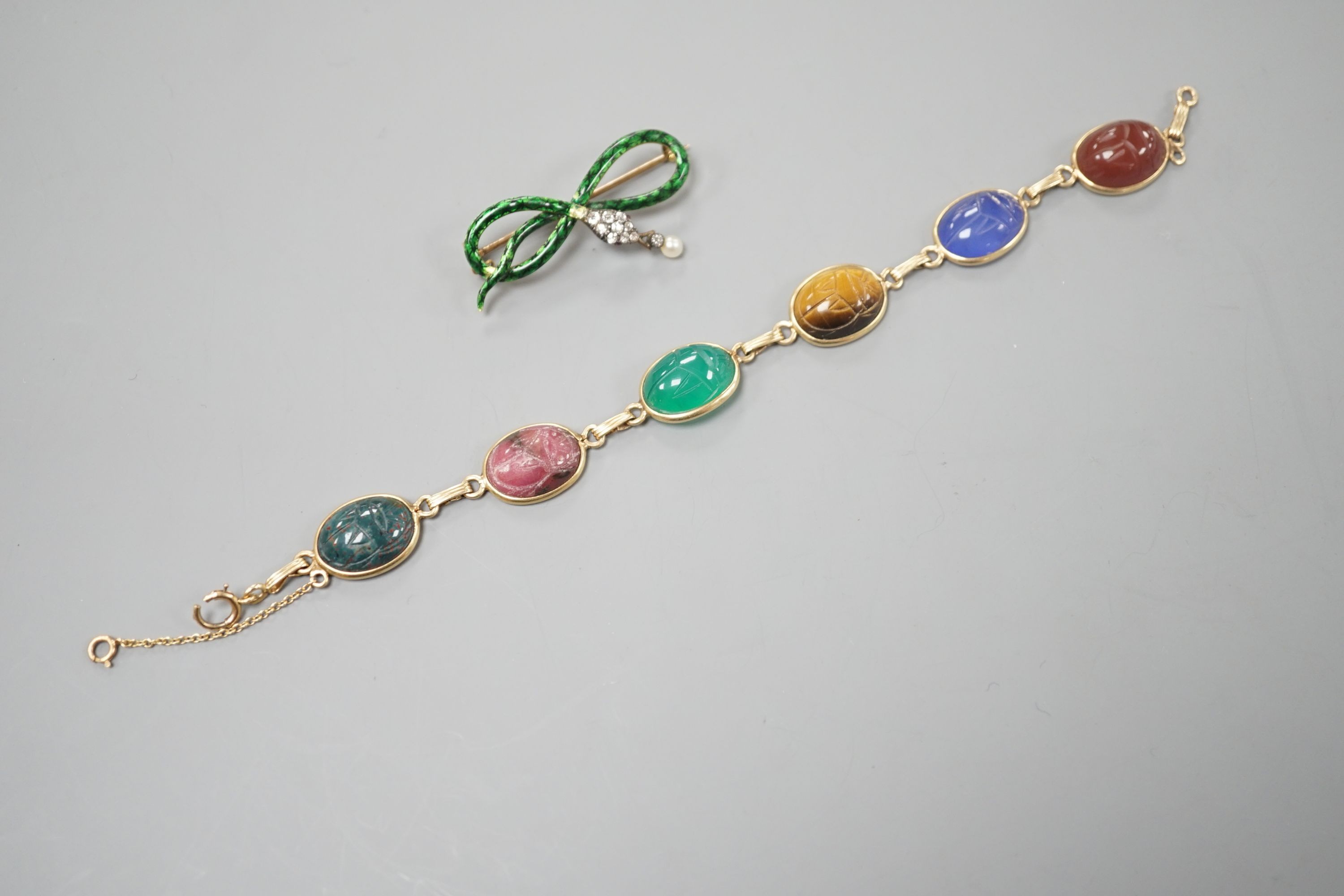 A 14k yellow metal and six stone multi gem set 'scarab' bracelet, 18.5cm, gross 15.4 grams and a yellow metal, diamond, drop pearl and green enamel set serpent brooch, gross 7.5 grams.